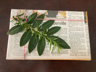 Gift wrapped in eco friendly newspaper with twine and foliage decoration