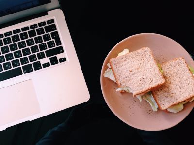 laptop and plate with sandwiches