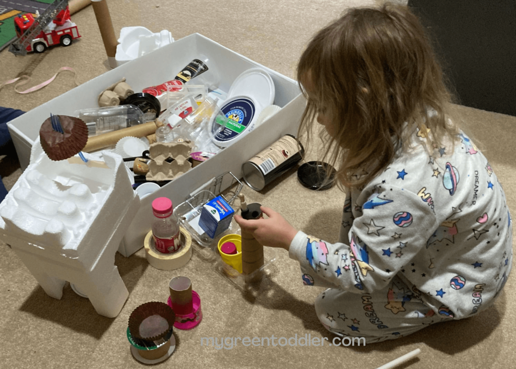 Girl building with recyclable materials