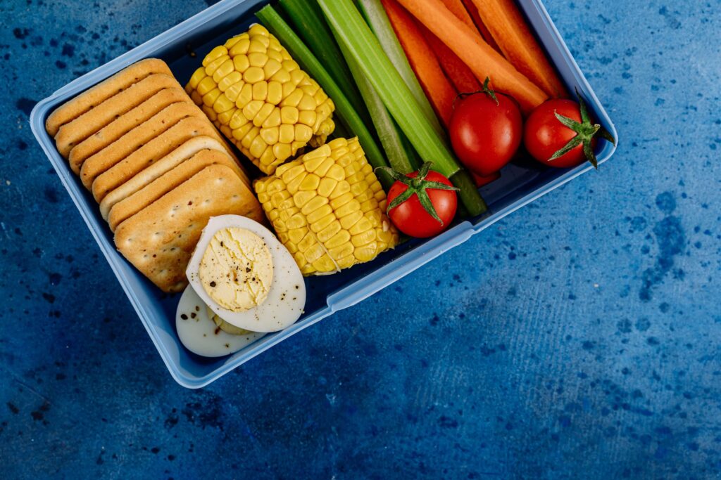 Blue lunch box filled with fresh food