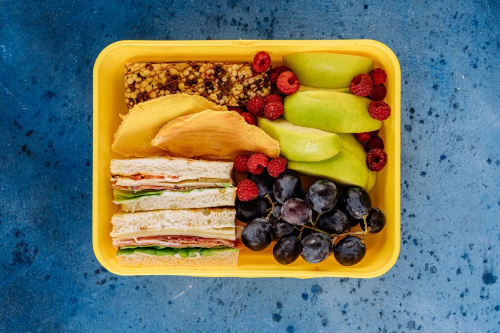 Yellow lunch box filled with fresh food