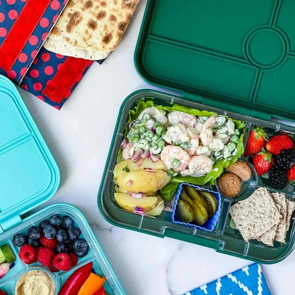 Waste free lunch box filled with food. Silicone patty pan used to separate food.